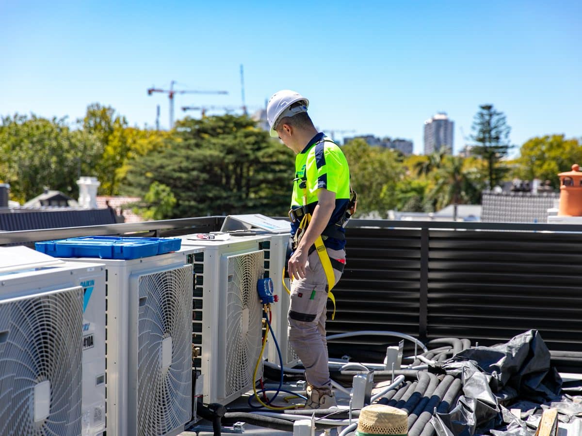 Rooftop plant servicing Skilful Star technician testing a rooftop VRV condenser bank with refrigeration gauges