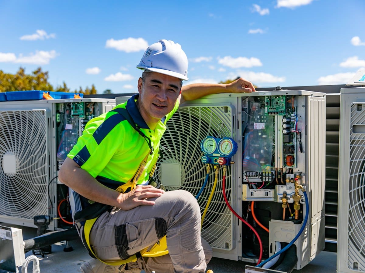 Skilful Star technician checking refrigerant pressures at a condensing unit